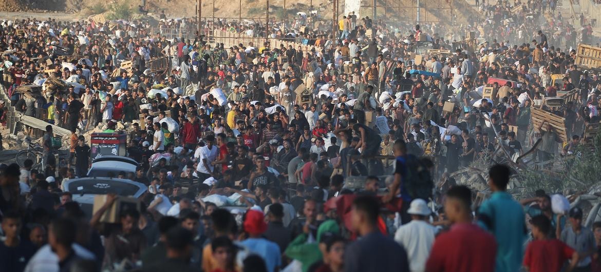 People gather in the vicinity of a food distribution by the Gaza Humanitarian Foundation (GHF).